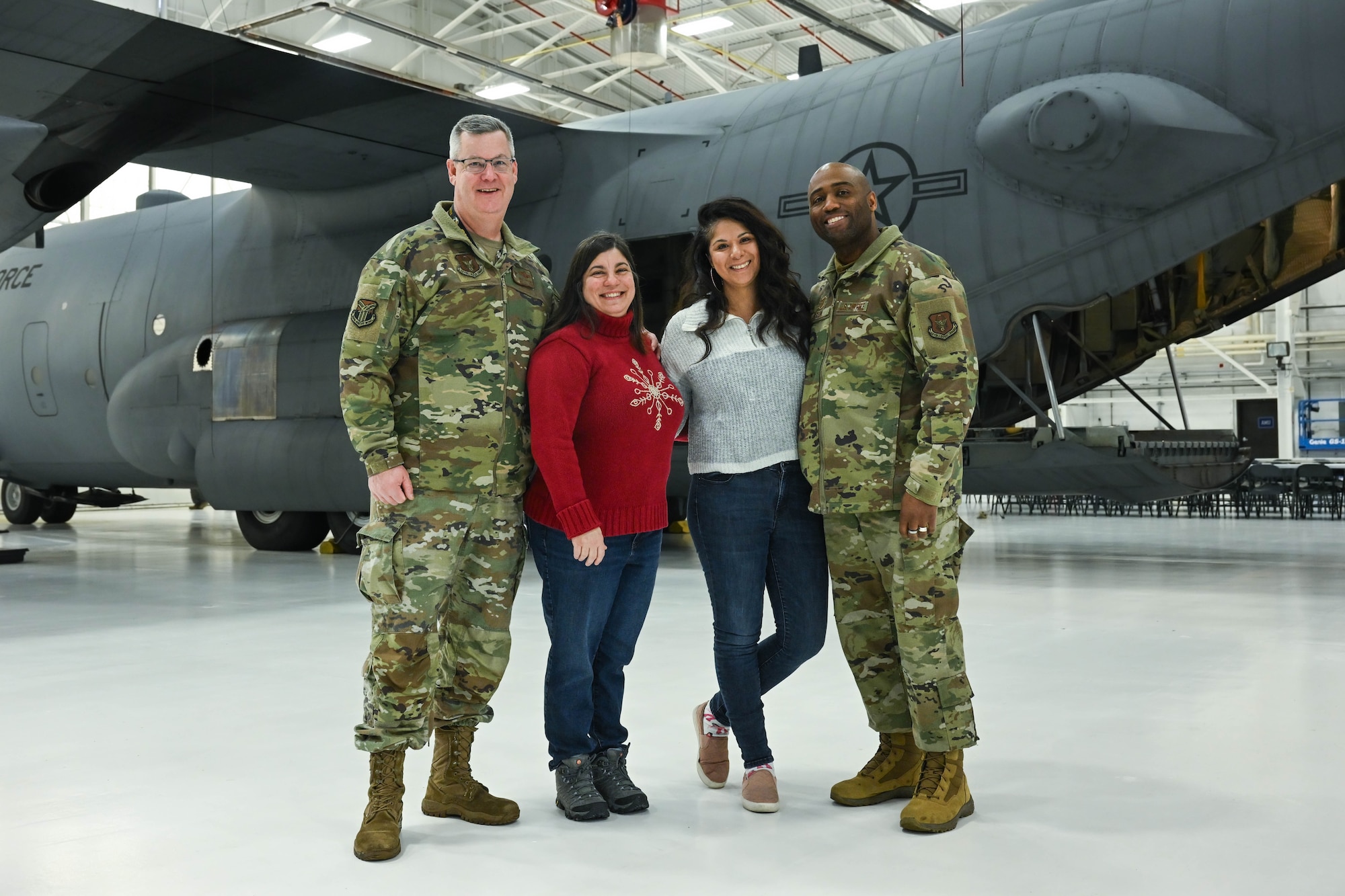 Col. Michael Maloney, 910th Airlift Wing commander, and Chief Master Sgt. Howard Dixon, 910th AW command chief, pose for a photo with their spouses prior to takeoff at Youngstown Air Reserve Station, Ohio, Dec. 7, 2024.