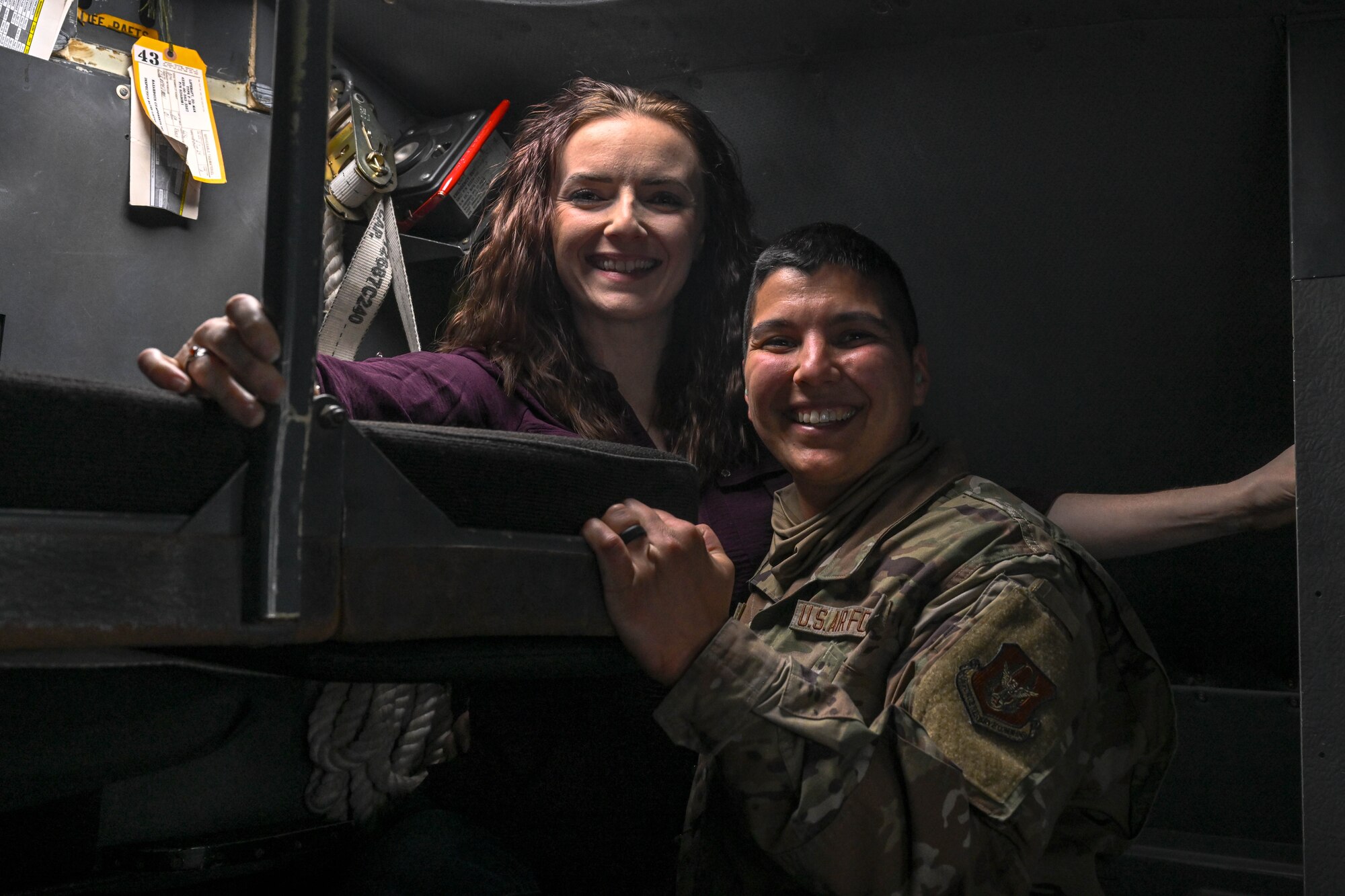 Staff Sgt. Khala Walls, a maintainer with the 910th Maintenance Squadron, poses for a photo with her spouse on the flightdeck during an incentive flight over the Allegheny River Valley, Dec. 7, 2024.