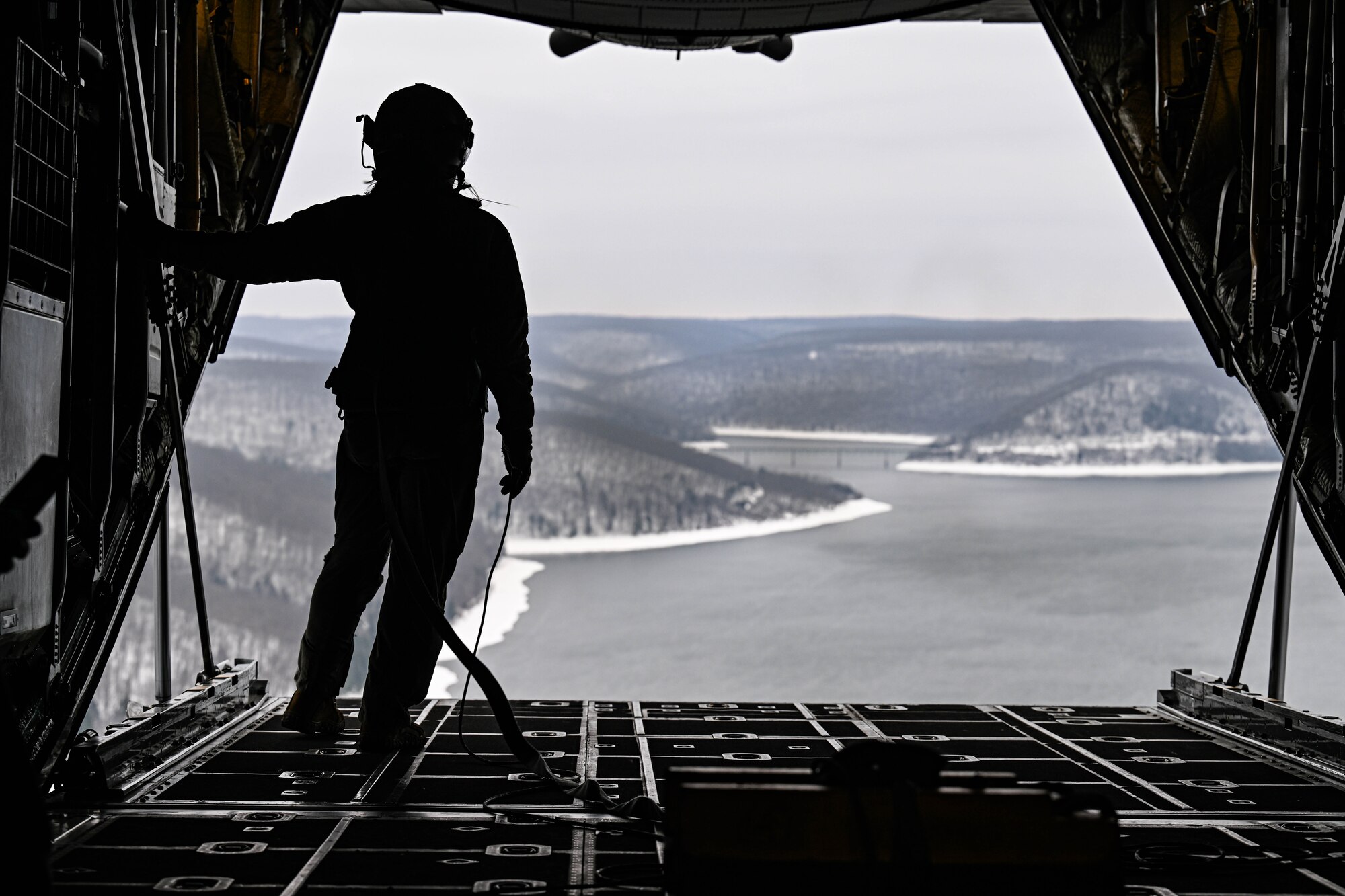 Tech. Sgt. Micaiah McCartney, a loadmaster with the 757th Airlift Squadron, stands on the ramp of a C-130H Hercules during an incentive flight for spouses, Dec. 7, 2024.