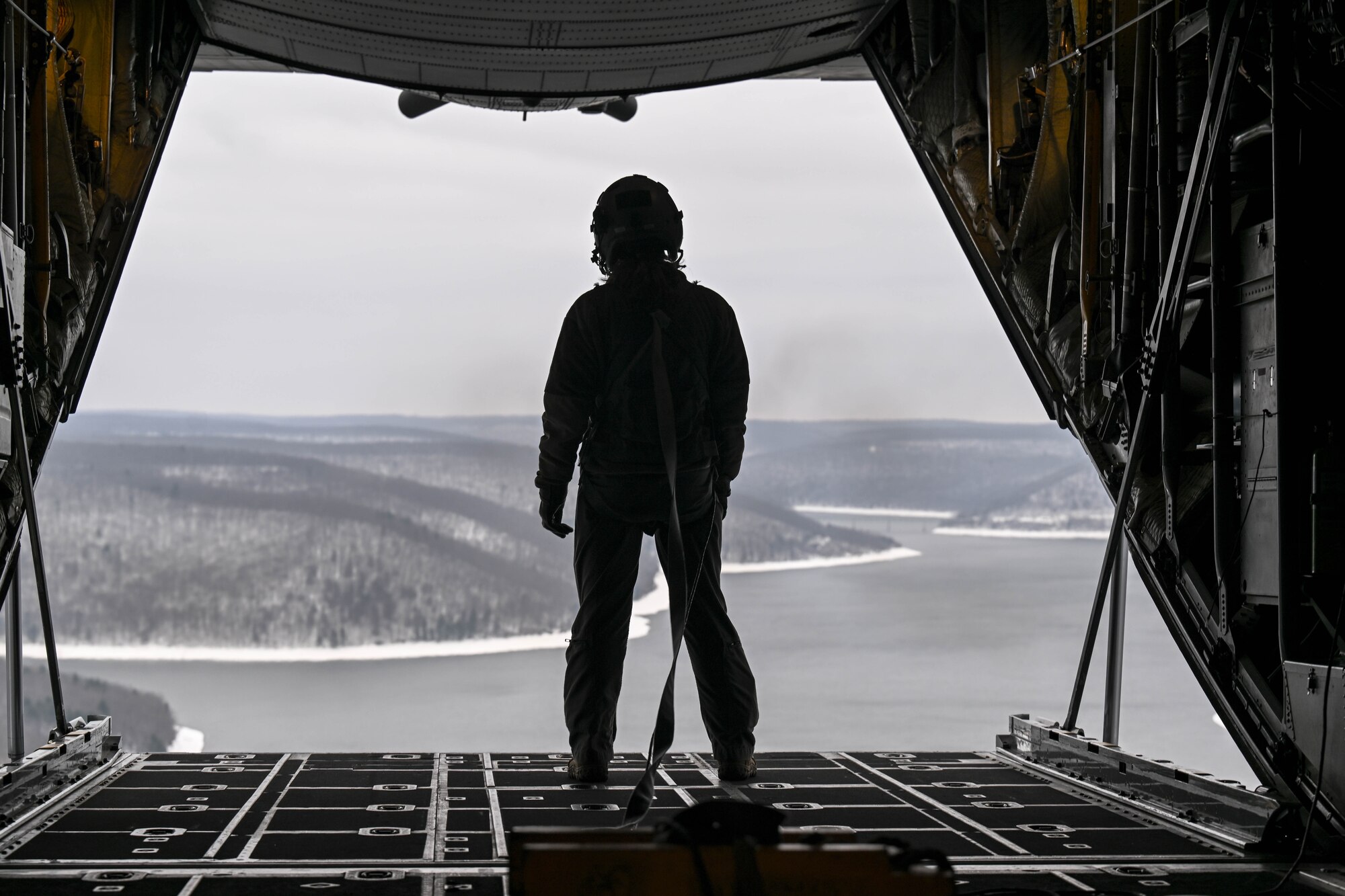 Tech. Sgt. Micaiah McCartney, a loadmaster with the 757th Airlift Squadron, stands on the ramp of a C-130H Hercules during an incentive flight for spouses, Dec. 7, 2024.