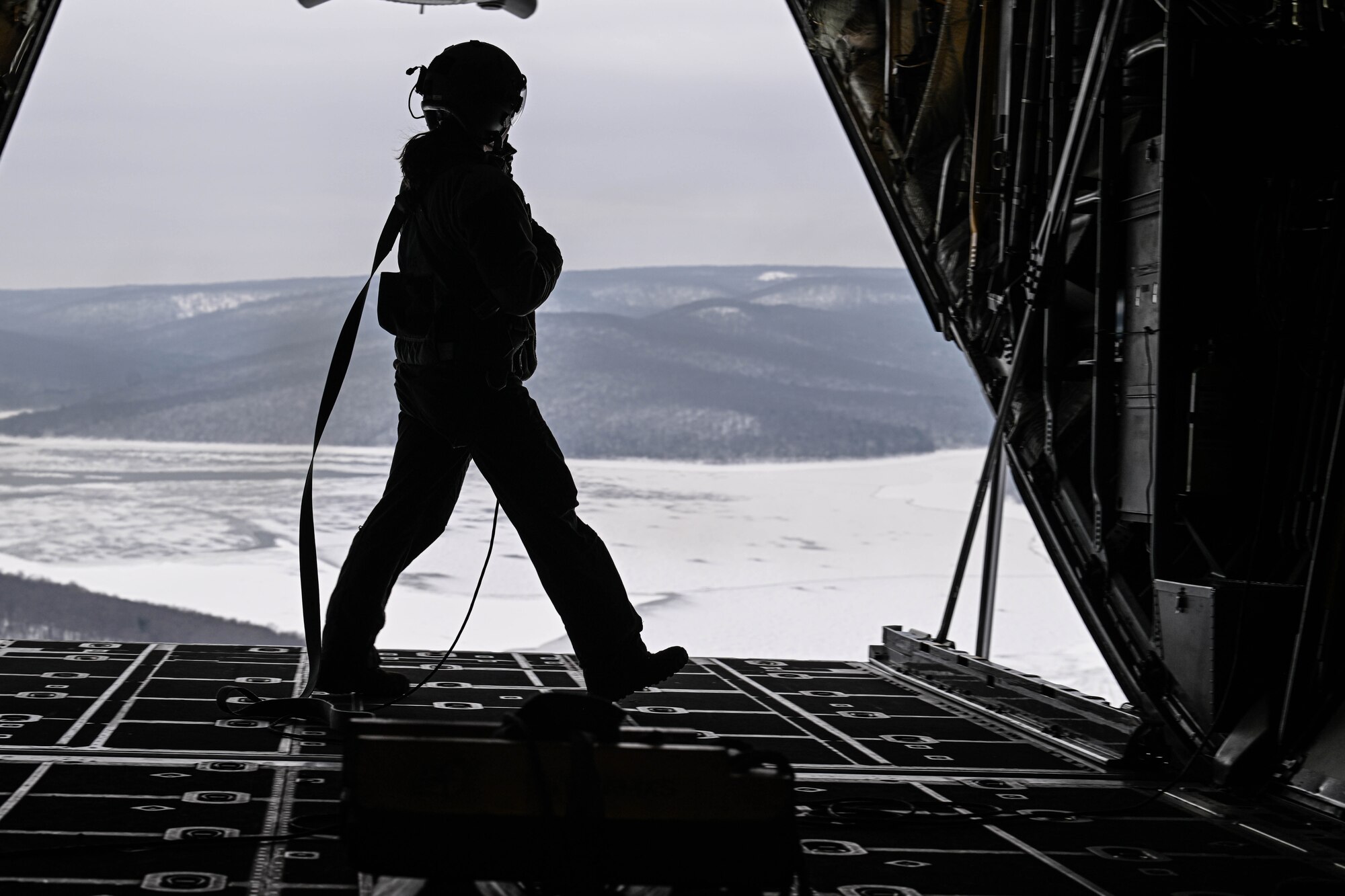 Tech. Sgt. Micaiah McCartney, a loadmaster with the 757th Airlift Squadron, walks on the ramp of a C-130H Hercules during an incentive flight for spouses, Dec. 7, 2024.