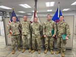 In photo from left, Lt. Col. Trevor DeVall, joint director of logistics for the Florida National Guard, gathers with Sgt. 1st Class Scott Jones, Master Sgt. Bernard Hudgens, and Capts. Justin Moran and James Kelly after awarding the New Hampshire MCT operators the Florida State Active Duty Medal on Oct. 15, 2024, in Gainesville, Florida. Courtesy photo.