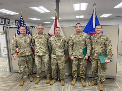 In photo from left, Lt. Col. Trevor DeVall, joint director of logistics for the Florida National Guard, gathers with Sgt. 1st Class Scott Jones, Master Sgt. Bernard Hudgens, and Capts. Justin Moran and James Kelly after awarding the New Hampshire MCT operators the Florida State Active Duty Medal on Oct. 15, 2024, in Gainesville, Florida. Courtesy photo.