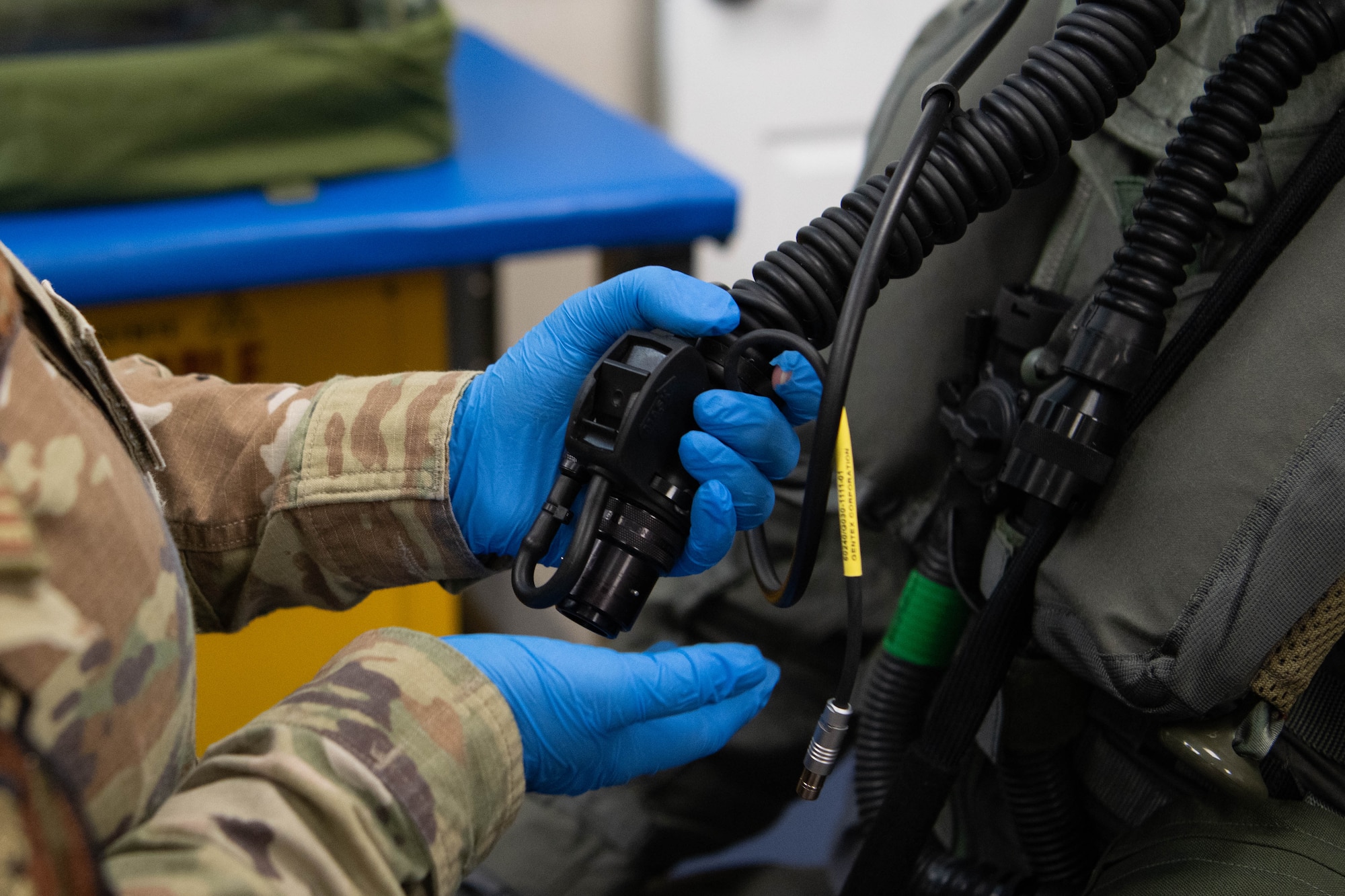 Pilot donning aircrew CBRN equipment