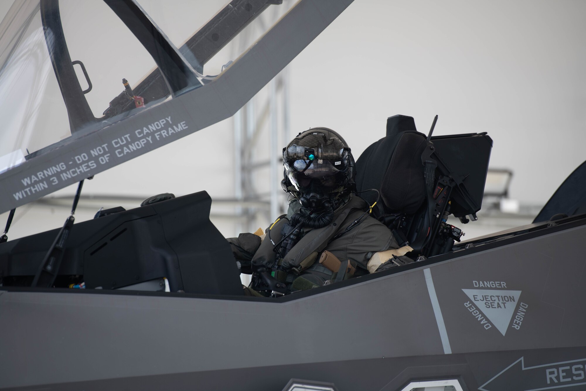 Pilot donning aircrew CBRN equipment
