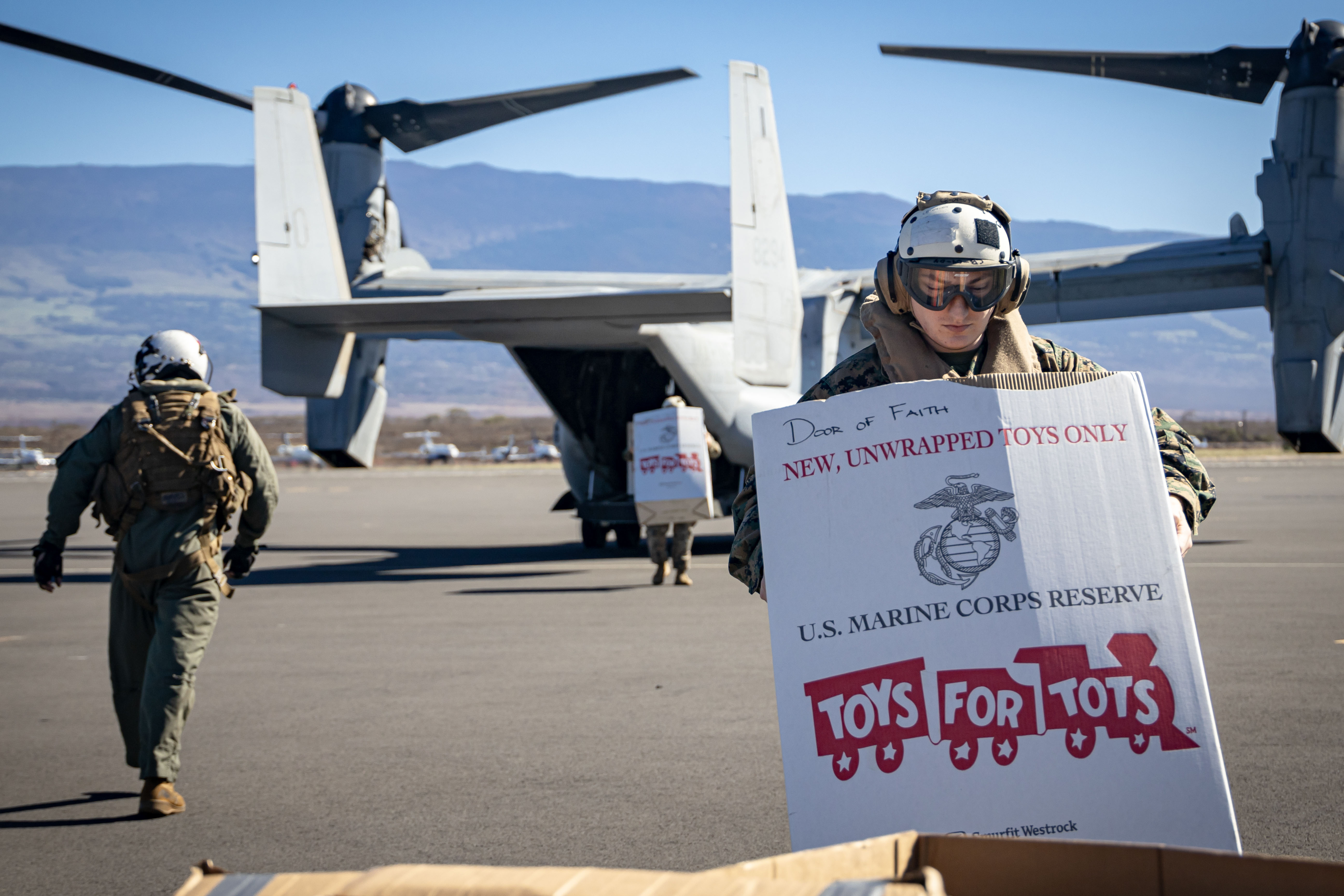 Marine Corps Staff Sgt. Ryan Weickum drops off a box of toys in support of Toys for Tots at Kahului Airport, Hawaii, Nov. 26, 2024.