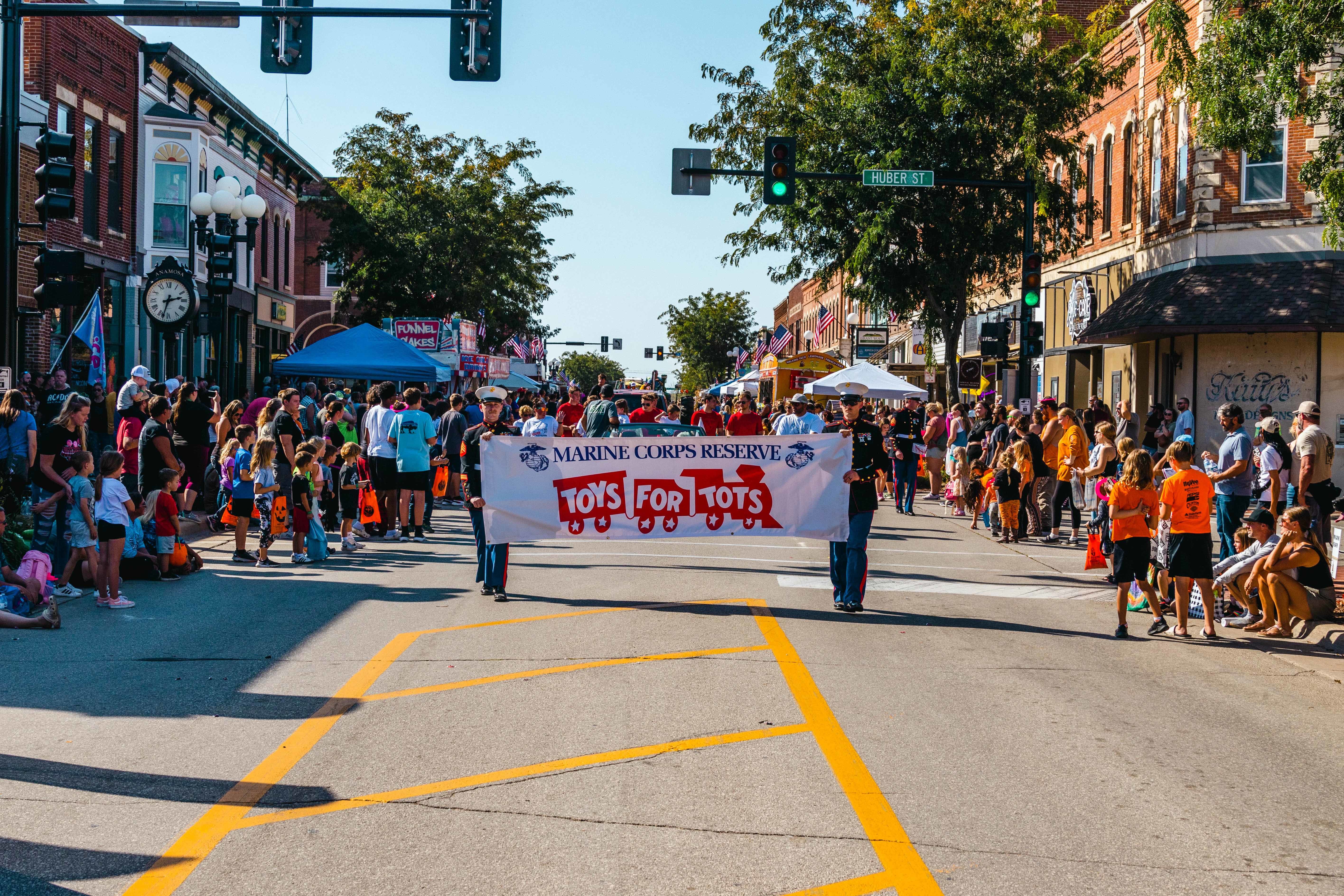 Marines present a Toys for Tots banner during the Anamosa Pumpkin Fest parade in Anamosa, Iowa, Oct. 5, 2024.