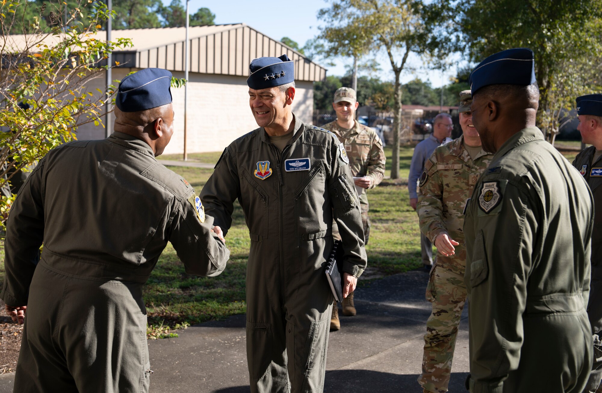 photo of uniformed U.S. Air Force Airmen outside shaking hands