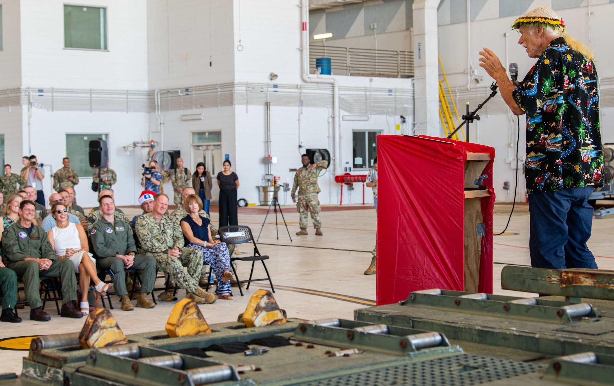 Bruce Best, known as “Brother Bruce,” Operation Christmas Drop island liaison and coordinator, addresses attendees during the Operation Christmas Drop 2024 “Push Ceremony” at Andersen Air Force Base, Guam, Dec. 9, 2024.