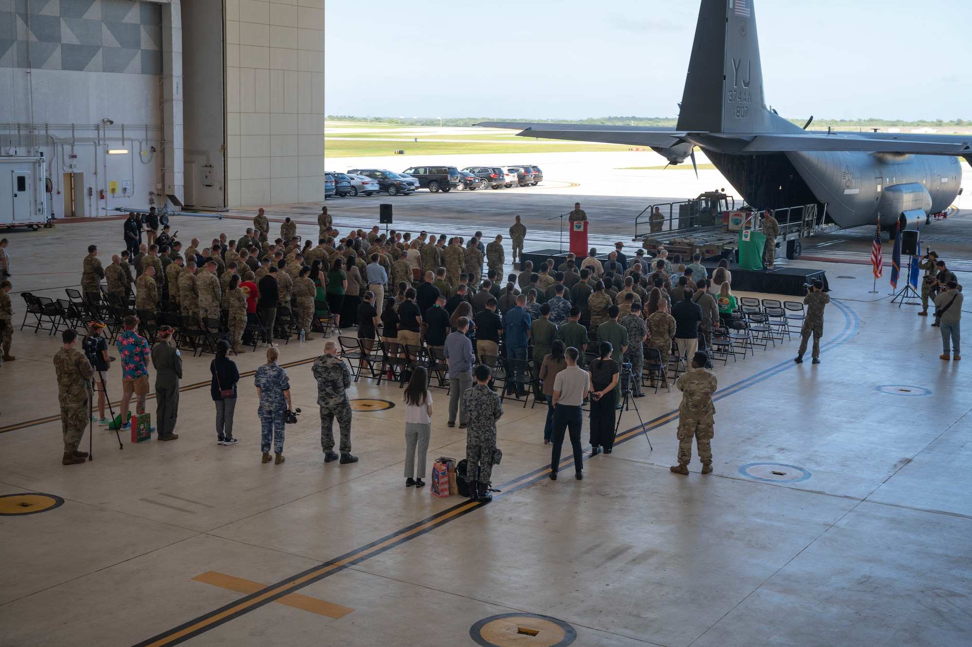 Guests listen to the emcees on stage while attending the Operation Christmas Drop push ceremony at Andersen Air Force Base, Guam, Dec. 9, 2024.