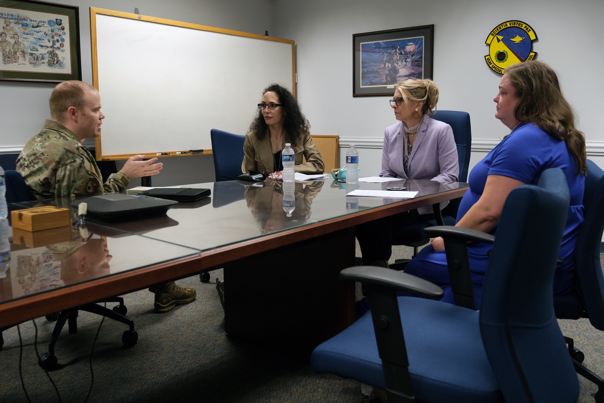 photo of civilians and U.S. Air Force Airmen sitting at a table