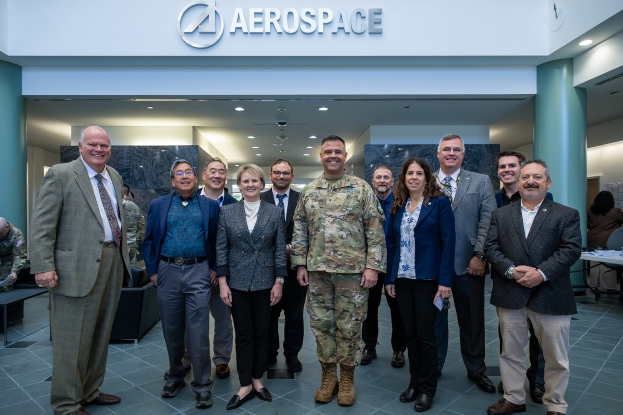 USSF Brig. Gen. Anthony J. Mastalir, Commander,  U.S. Space Forces Indo-Pacific, center, joined by, from left, Daniel P. Burns, Terry Lee, David Lee, Lara Schmidt, Danny Fain, Michael Baxter, Susan Herblock, Jack Clarke, Matthew Johns and Andre Doumitt with The Aerospace Corporation on Oct. 29, 2024, day 1 of the Space Warfighters Day conference at the Aerospace campus in El Segundo Calif. The two-day event paired USINDOPACOM, the nation’s largest and oldest combatant command, with the U.S. Space Force, the nation’s newest – and smallest – military branch, for the purpose of bringing game-changing capabilities to bear in defense of our Nation, Allies, and strategic interests.