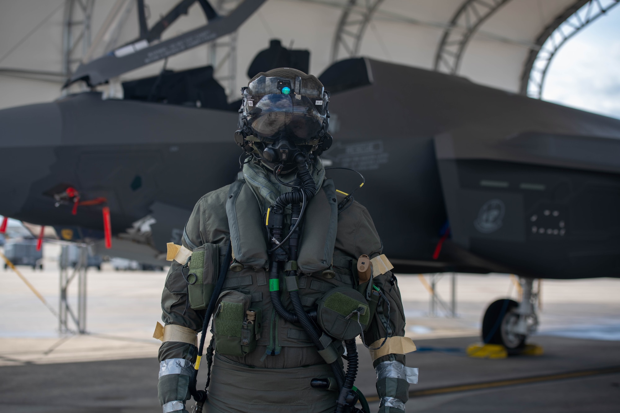Pilot donning aircrew CBRN equipment
