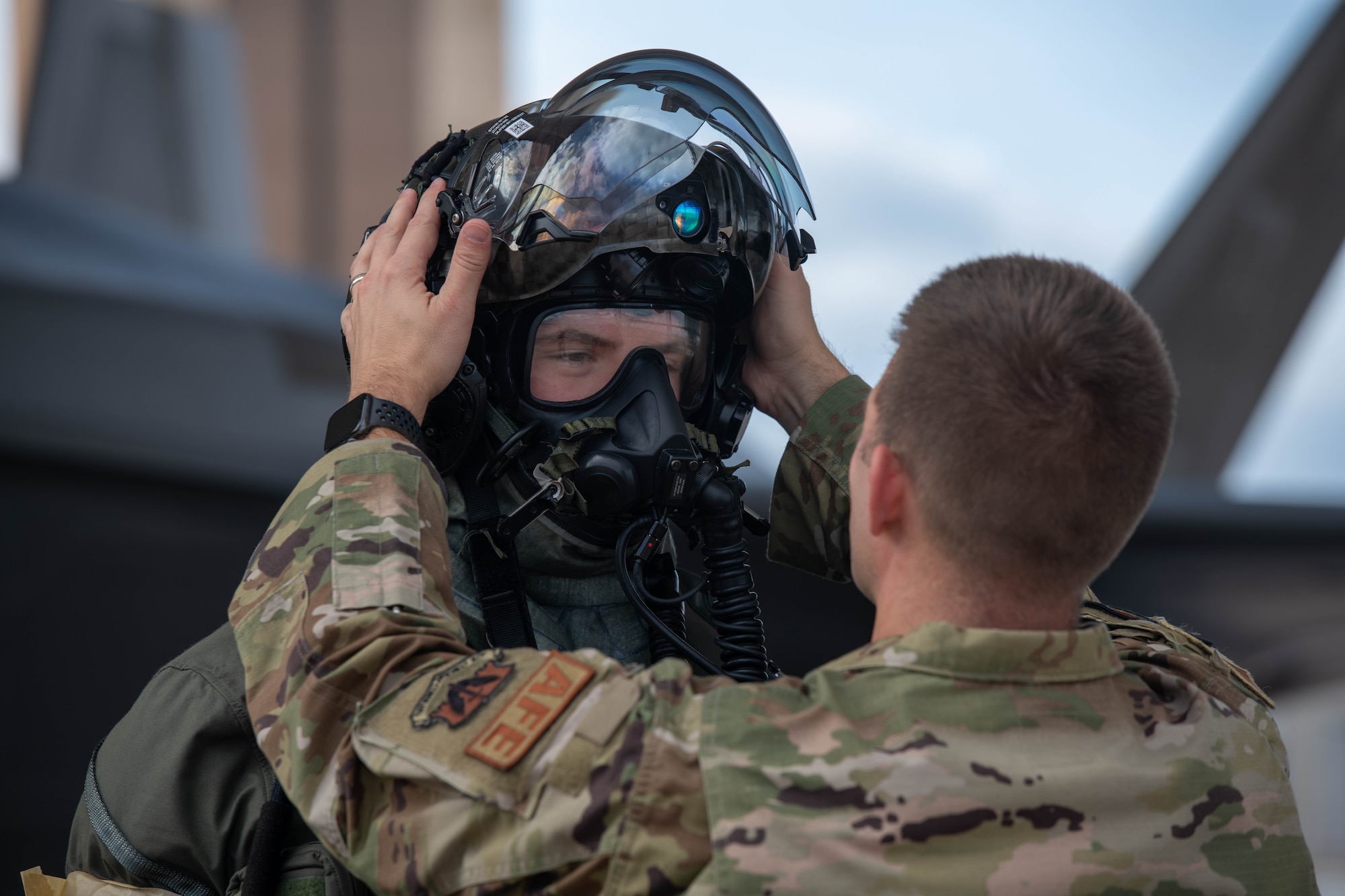 Pilot donning aircrew CBRN equipment