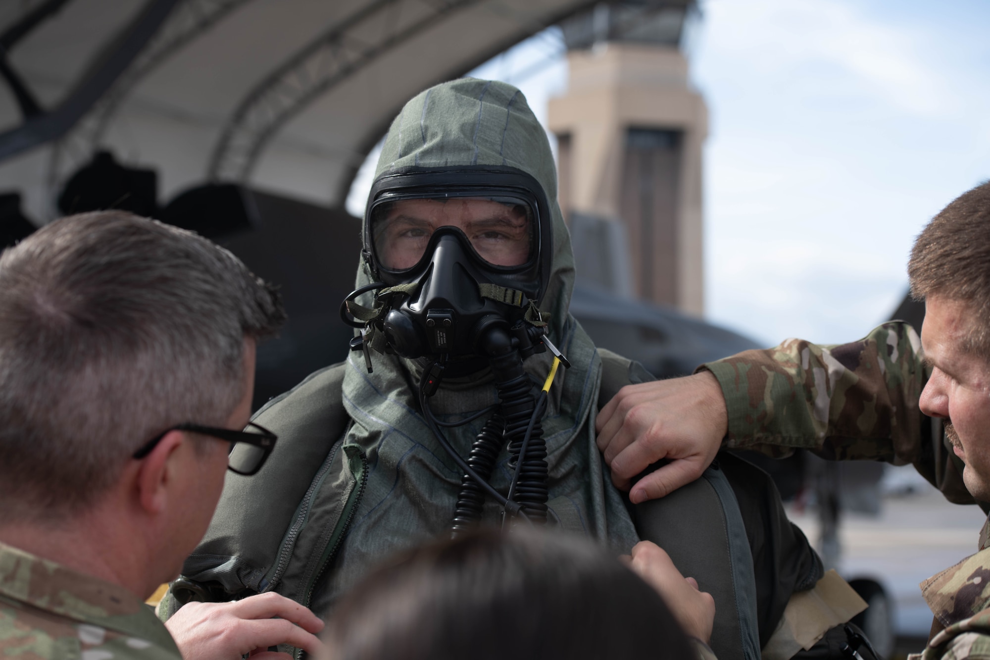 Pilot donning aircrew CBRN equipment