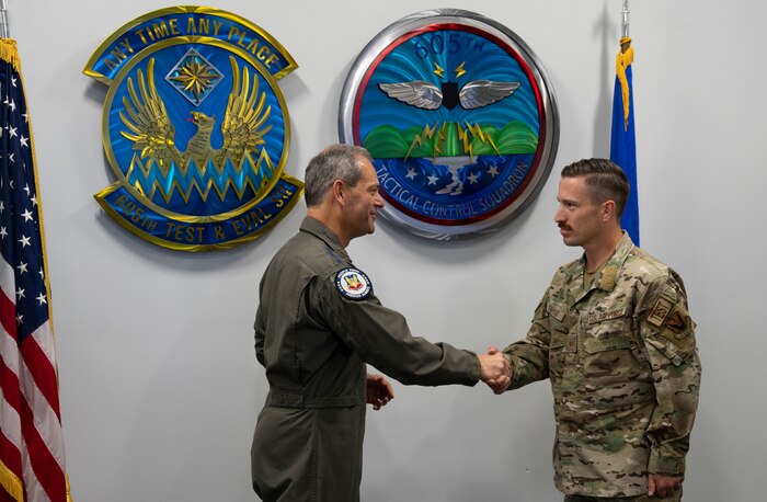 photo of two uniformed U.S. Air Force Airmen shaking hands