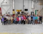 FRCE and DLA employees stand in front of the depot’s final completed F402 engine.