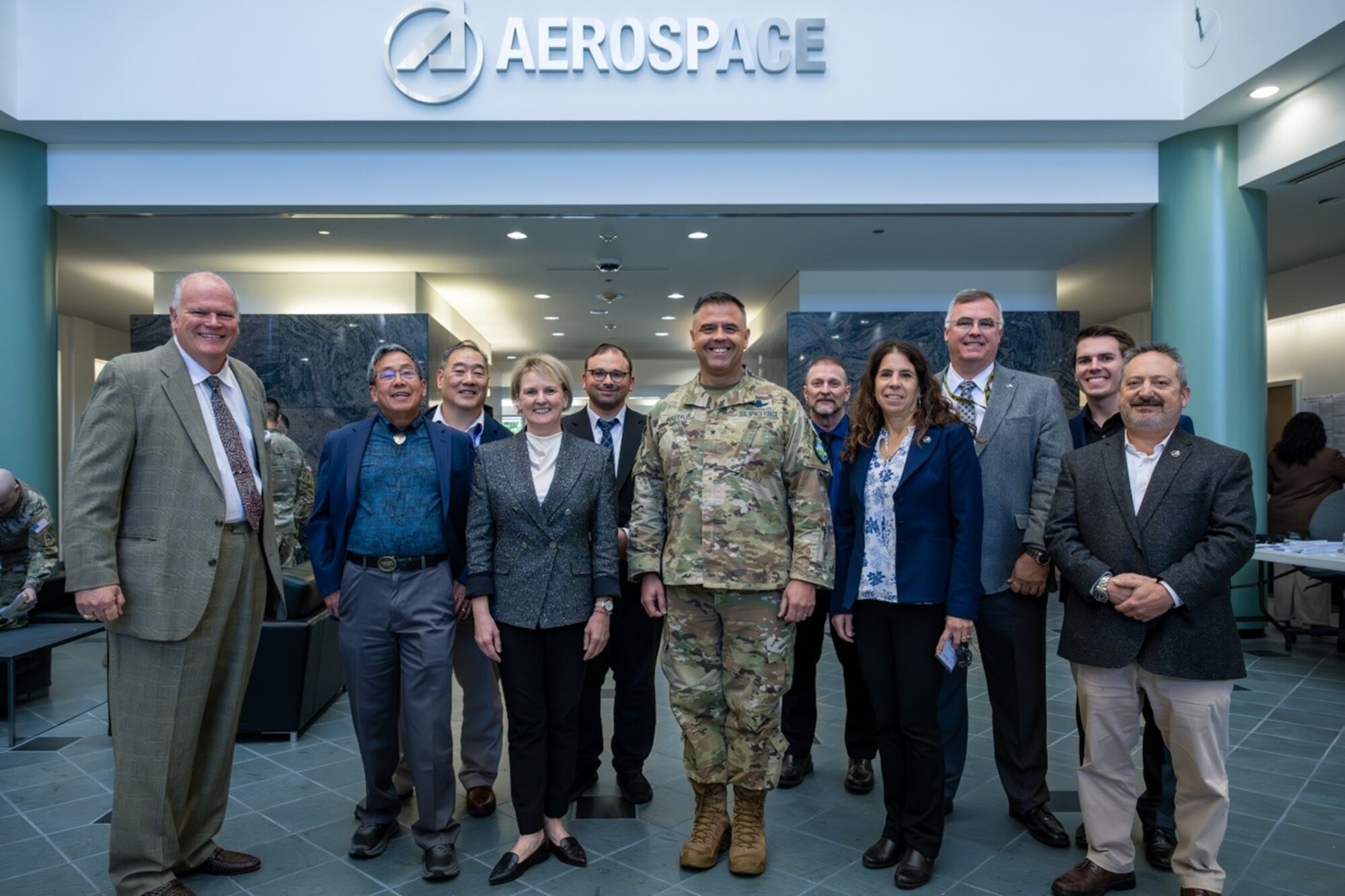 USSF Brig. Gen. Anthony J. Mastalir, Commander,  U.S. Space Forces Indo-Pacific, center, joined by, from left, Daniel P. Burns, Terry Lee, David Lee, Lara Schmidt, Danny Fain, Michael Baxter, Susan Herblock, Jack Clarke, Matthew Johns and Andre Doumitt with The Aerospace Corporation on Oct. 29, 2024, day 1 of the Space Warfighters Day conference at the Aerospace campus in El Segundo Calif. The two-day event paired USINDOPACOM, the nation’s largest and oldest combatant command, with the U.S. Space Force, the nation’s newest – and smallest – military branch, for the purpose of bringing game-changing capabilities to bear in defense of our Nation, Allies, and strategic interests.