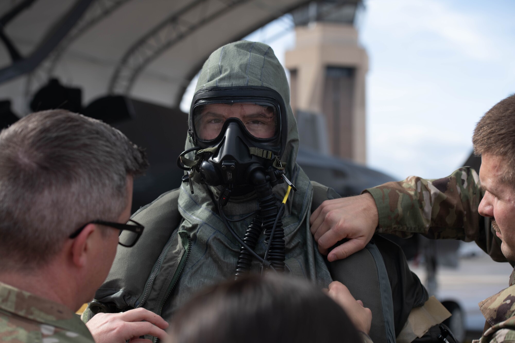 Pilot donning aircrew CBRN equipment