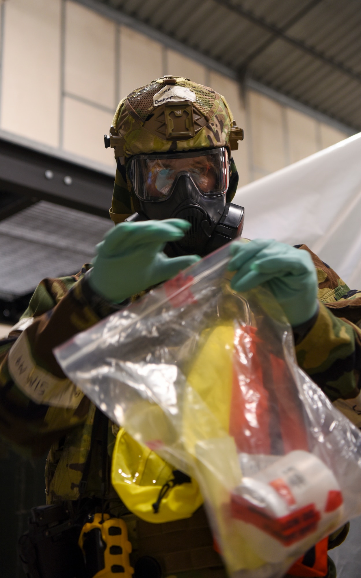 U.S. Air Force Airman 1st Class Justin Baker, 100th Civil Engineer Squadron emergency management journeyman, puts a sample of a simulated narcotic into a plastic bag for transport during a Prime Base Engineer Emergency Force (Prime BEEF) readiness day at Royal Air Force Mildenhall, England, Nov. 21, 2024.