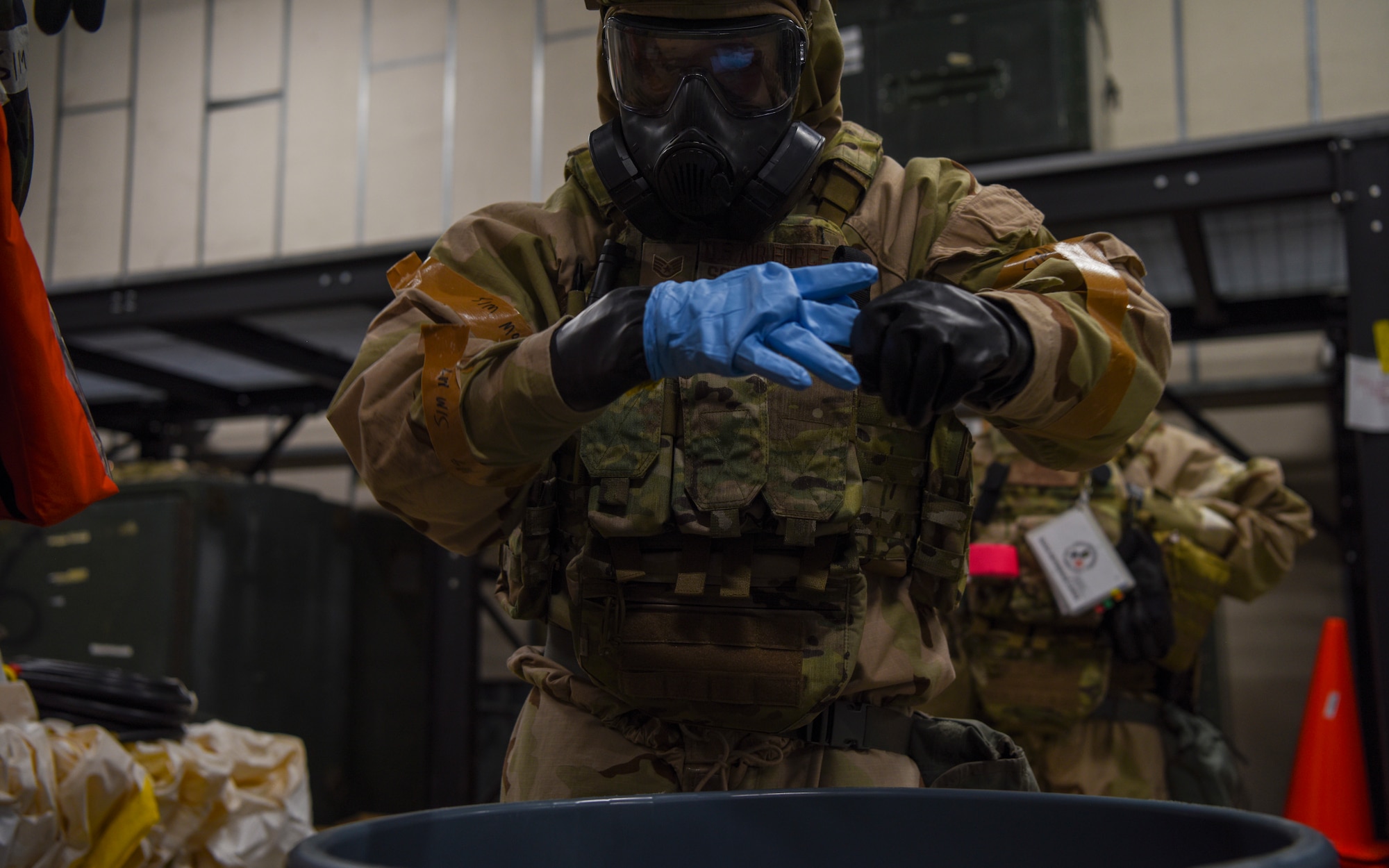 U.S. Air Force Staff Sgt. Philip Schopmeyer, 100th Civil Engineer Squadron emergency management journeyman, removed gloves after performing a simulated narcotics collection during a Prime Base Engineer Emergency Force (Prime BEEF) readiness day at Royal Air Force Mildenhall, England, Nov. 21, 2024.