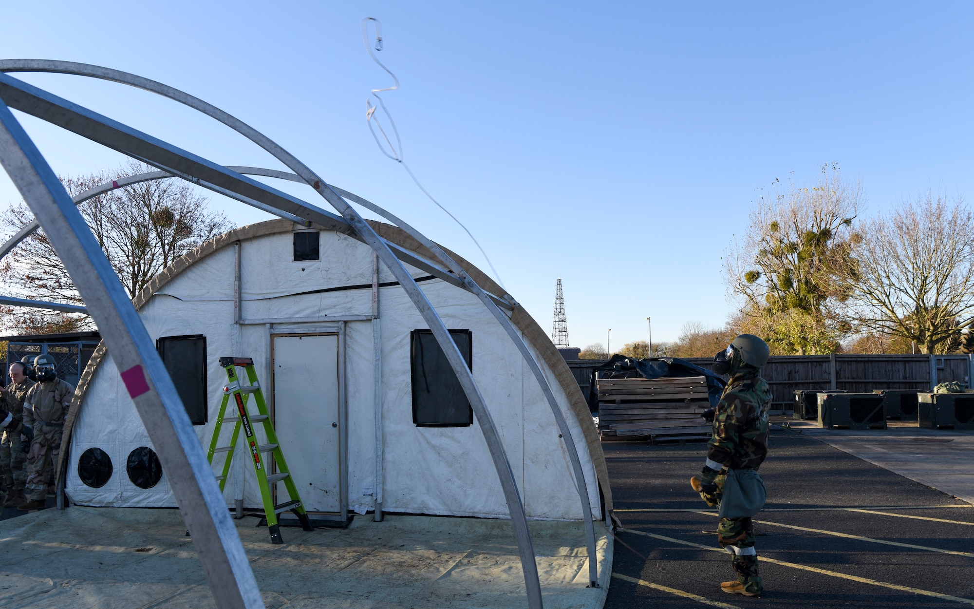 A U.S. Airman assigned to the 100th Civil Engineer Squadron throws a rope over a tent frame so that other 100th CES Airmen can pull over the tent cover during a Prime Base Engineer Emergency Force (Prime BEEF) readiness day at Royal Air Force Mildenhall, England, Nov. 21, 2024.