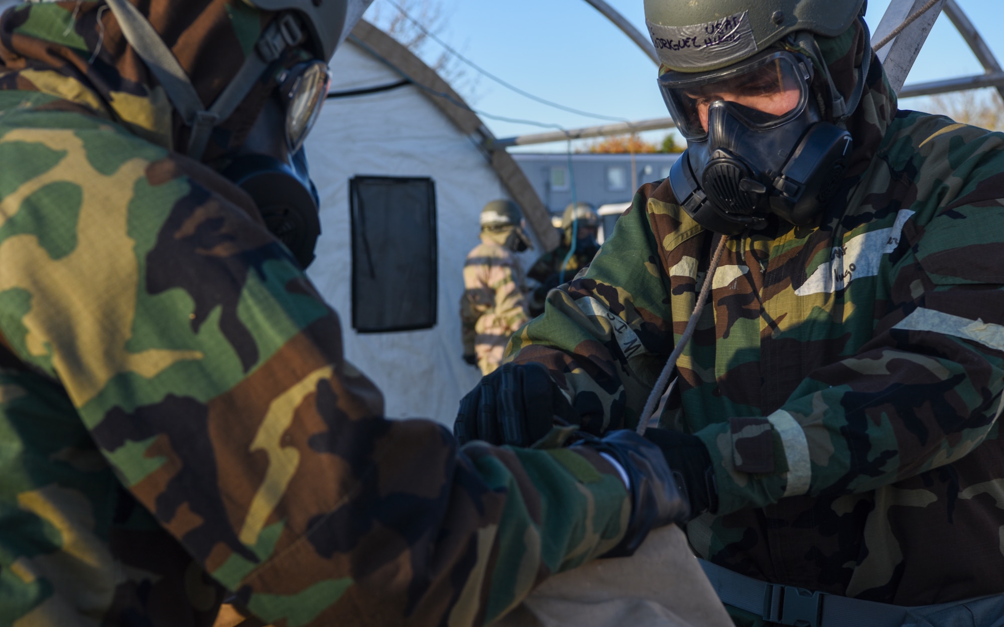 U.S. Airmen assigned to the 100th Civil Engineer Squadron attach a rope to the top covering of a tent during a Prime Base Engineer Emergency Force (Prime BEEF) readiness day at Royal Air Force Mildenhall, England, Nov. 21, 2024.