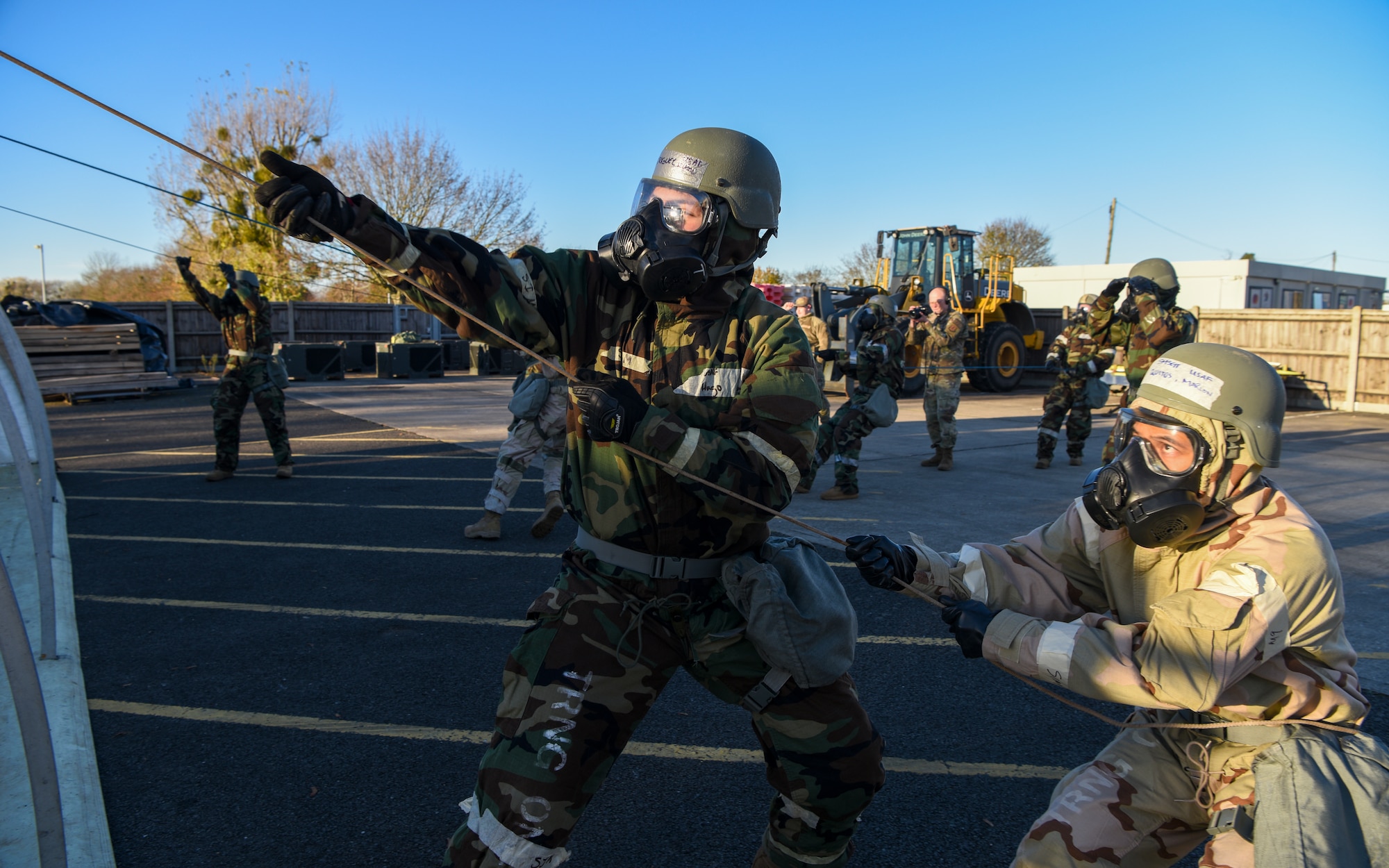 U.S. Airmen assigned to the 100th Civil Engineer Squadron pull on ropes to bring the top covering of a tent over during a Prime Base Engineer Emergency Force (Prime BEEF) readiness day at Royal Air Force Mildenhall, England, Nov. 21, 2024.
