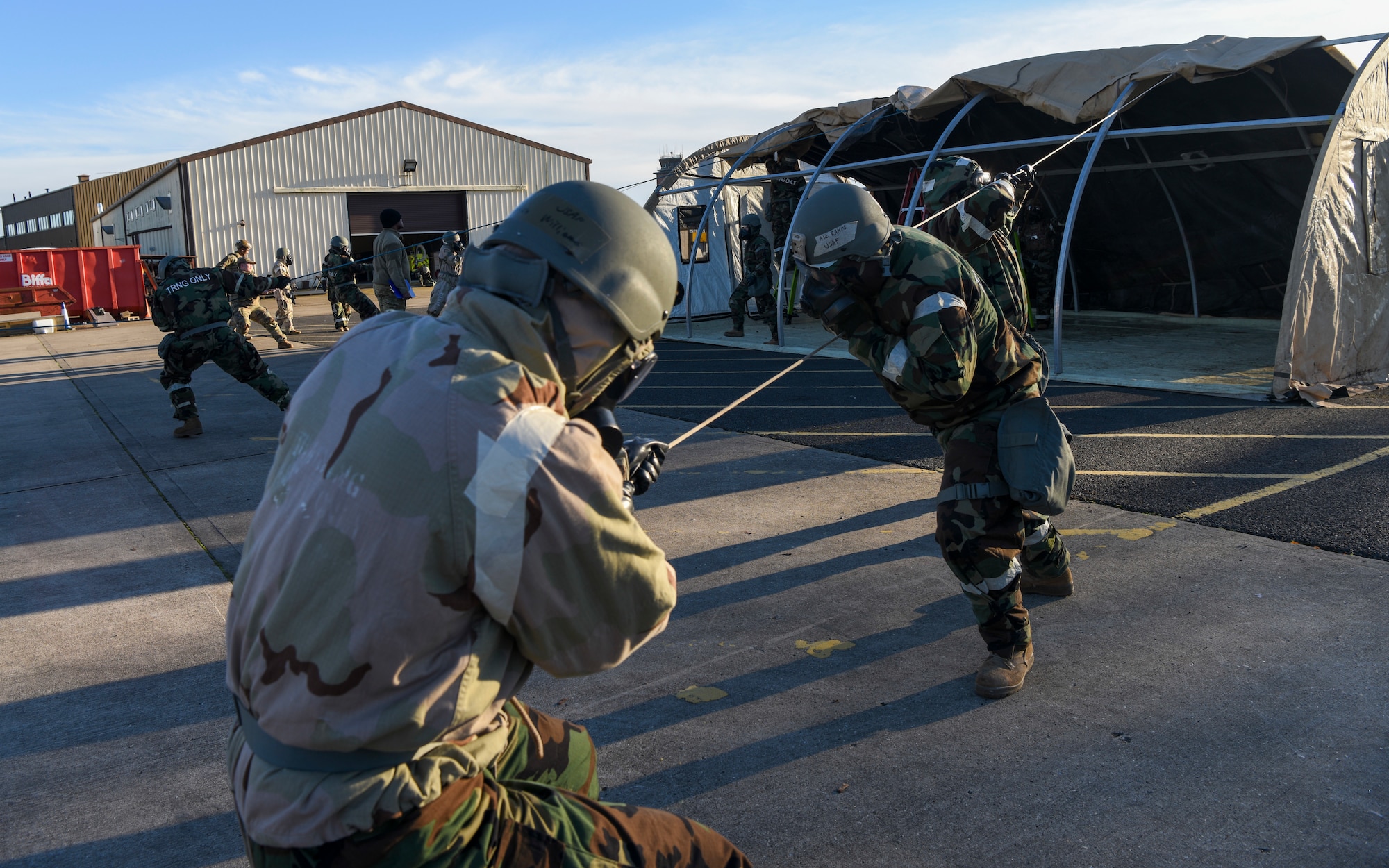 U.S. Airmen assigned to the 100th Civil Engineer Squadron pull on ropes to bring the top covering of a tent over during a Prime Base Engineer Emergency Force (Prime BEEF) readiness day at Royal Air Force Mildenhall, England, Nov. 21, 2024.