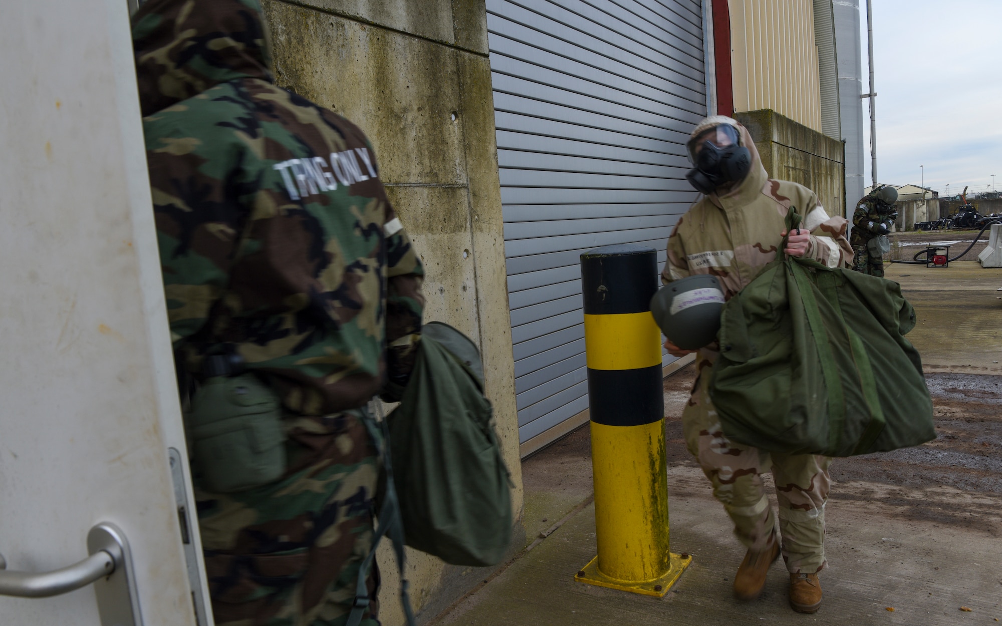 U.S. Airmen assigned to the 100th Civil Engineer Squadron enter a semi-hardened facility as part of a drill during a Prime Base Engineer Emergency Force (Prime BEEF) readiness day at Royal Air Force Mildenhall, England, Nov. 21, 2024.