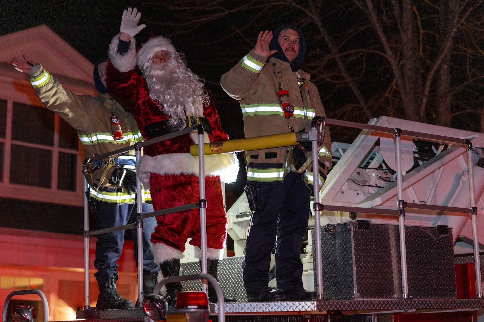 Santa Claus and firefighters wave at residents of base housing as he travels through the neighborhoods on Marine Corps Base Quantico, Virginia, Dec. 7, 2024. The event is held annually where Quantico Fire and Emergency Services escort Santa around the installation and the Town of Quantico to bring holiday cheer to the children and families. (U.S. Marine Corps photo by Lance Cpl. Braydon Rogers)