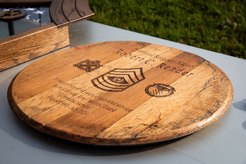 A plaque made from a bourbon barrel end for Command Sgt. Maj. Robert C. Render's retirement in Harrodsburg, Kentucky on June 14, 2024. Render is retiring from the Kentucky Army National Guard with 43 years, and 10 months; he is longest serving member of the Kentucky National Guard. (U.S. Army National Guard photo by Sgt. 1st Class Andrew Dickson)