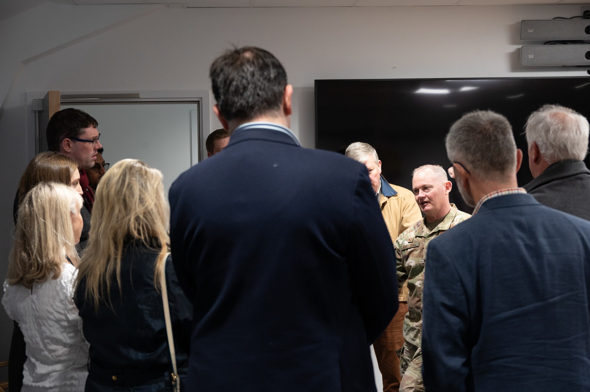 U.S. Air Force Col. D. Landon Phillips, 501st Combat Support Wing commander (CSW), greets visitors before a tour