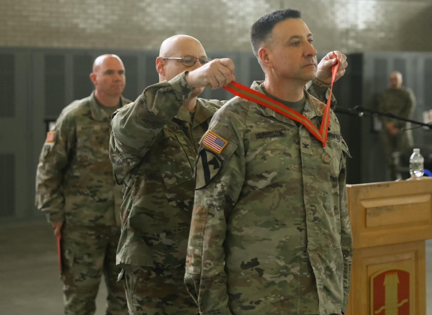 Col. Davis Ulricson, outgoing commander of the 197th Field Artillery Brigade, receives the Ancient Order of Saint Barbara medal during a change of command ceremony Dec. 7, 2024, at the Manchester armory.