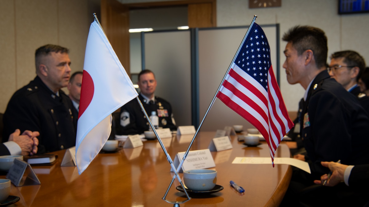 Japan Air Self-Defense Force Maj. Gen. Takahiro Kubota, Air Staff Office Defense Planning and Policy Department director general,  and U.S. Space Force Brig. Gen. Anthony Mastalir, Commander of U.S. Space Forces Indo-Pacific, as well as other guardians, engage in a discussion during a Space Force engagement at the Japan Ministry of Defense in Tokyo, Japan, Dec. 2, 2024. A U.S. flag and Japanese flag placed on the table between them symbolize the partnership and cooperation in space operations. (U.S. Air Force photo by Airman 1st Class Cayla Hunt)