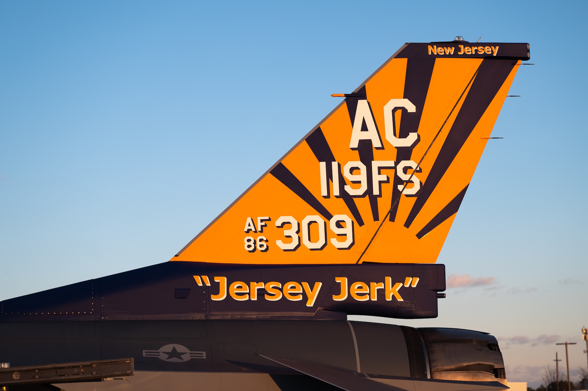The painted tail of an F-16 C fighter jet sits on display.