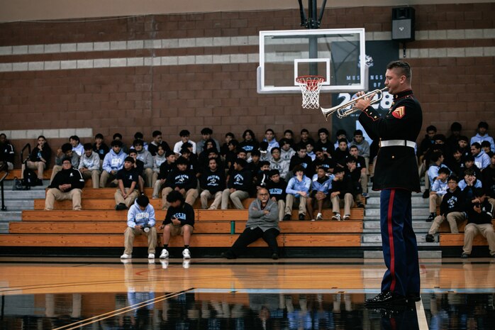 U.S. Marine Corps Cpl. Jacob Daniels, trumpeter, with Marine Band San Diego, Headquarters and Service Battalion, MCRD San Diego, performs for students at Salesian High School in Los Angeles, California, Nov. 20, 2024. The Marine Band San Diego’s job is to provide ceremonial music, boost morale and participate in outreach work and attend events and ceremonies. (U.S. Marine Corps photo by Cpl. Sarah M. Grawcock)