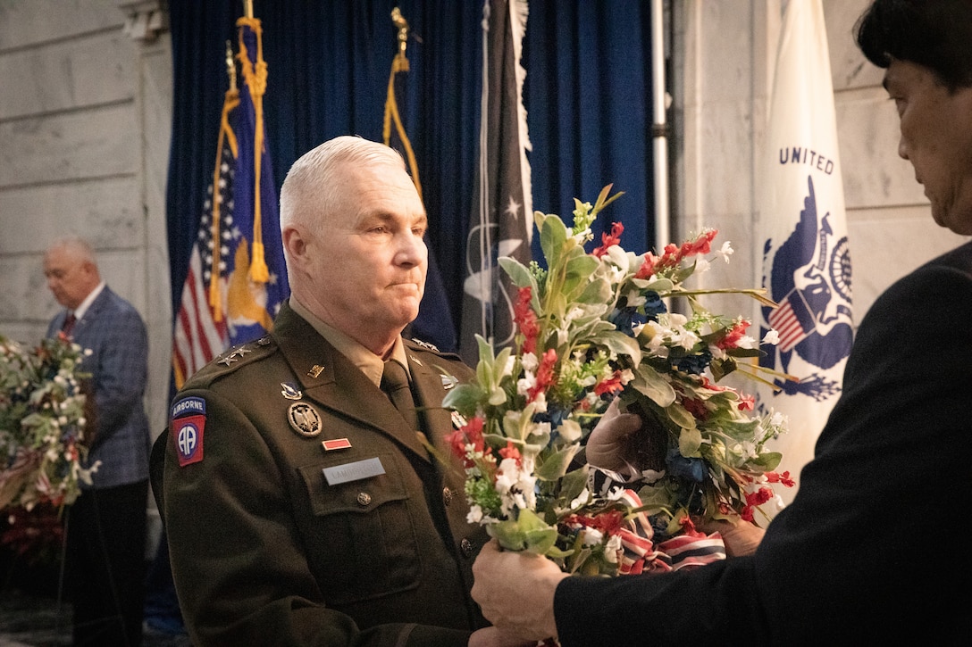 U.S. Army Maj. Gen. Haldane B. Lamberton, adjutant general of Kentucky, accepts the wreath he will lay in honor of prisoners-of war and missing-in-action at the Kentucky Department of Veterans Affairs wreath laying ceremony at the Capitol Rotunda in Frankfort, Kentucky on Dec. 9, 2024. The Kentucky National Guard supported the ceremony by providing music from the 202nd Band and a color guard from the 63rd Theater Aviation Brigade. (U.S. Army National Guard photo by Andy Dickson)