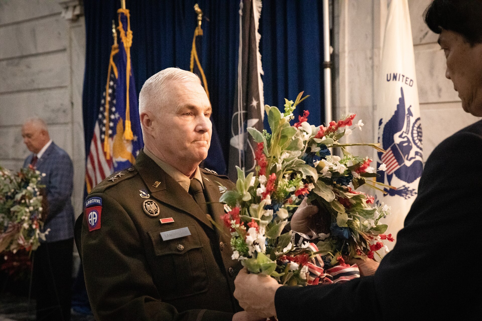 U.S. Army Maj. Gen. Haldane B. Lamberton, adjutant general of Kentucky, accepts the wreath he will lay in honor of prisoners-of war and missing-in-action at the Kentucky Department of Veterans Affairs wreath laying ceremony at the Capitol Rotunda in Frankfort, Kentucky on Dec. 9, 2024. The Kentucky National Guard supported the ceremony by providing music from the 202nd Band and a color guard from the 63rd Theater Aviation Brigade. (U.S. Army National Guard photo by Andy Dickson)