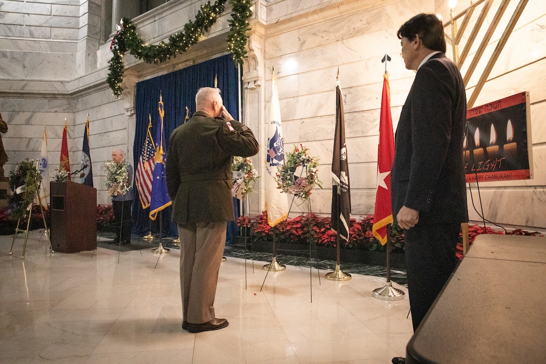 U.S. Army Maj. Gen. Haldane B. Lamberton, adjutant general of Kentucky, salutes the wreath he hung in honor of prisoners-of war and missing-in-action at the Kentucky Department of Veterans Affairs wreath laying ceremony at the Capitol Rotunda in Frankfort, Kentucky on Dec. 9, 2024. The Kentucky National Guard supported the ceremony by providing music from the 202nd Band and a color guard from the 63rd Theater Aviation Brigade. (U.S. Army National Guard photo by Andy Dickson)