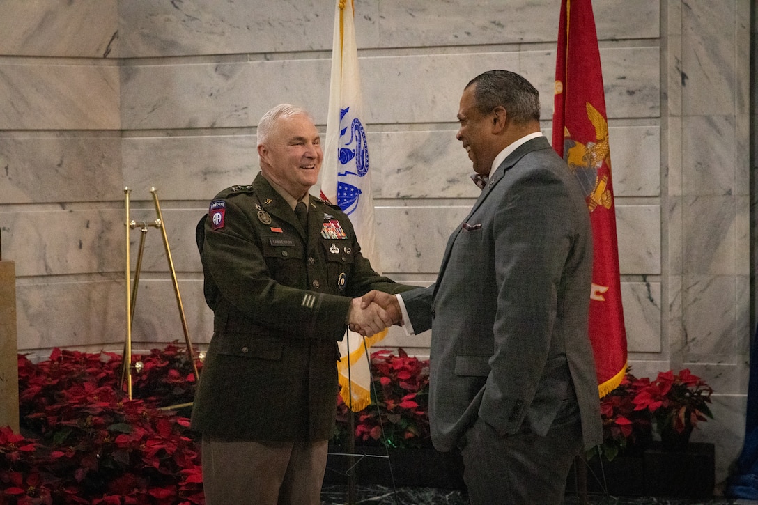 U.S. Army Maj. Gen. Haldane B. Lamberton, adjutant general of Kentucky, shakes hands with Mr. Juan Renaud, the deputy commissioner of the Kentucky Department of Veterans Affairs (KDVA), at the KDVA wreath laying ceremony at the Capitol Rotunda in Frankfort, Kentucky on Dec. 9, 2024. The Kentucky National Guard supported the ceremony by providing music from the 202nd Band and a color guard from the 63rd Theater Aviation Brigade. (U.S. Army National Guard photo by Andy Dickson)