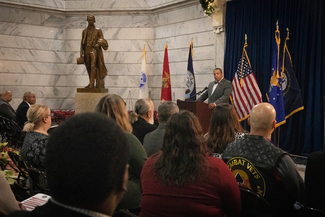 Mr. Juan Renaud speaks to the audience at the Kentucky Department of Veterans Affairs wreath laying ceremony at the Capitol Rotunda in Frankfort, Kentucky on Dec. 9, 2024. The Kentucky National Guard supported the ceremony by providing music from the 202nd Band and a color guard from the 63rd Theater Aviation Brigade. (U.S. Army National Guard photo by Andy Dickson)