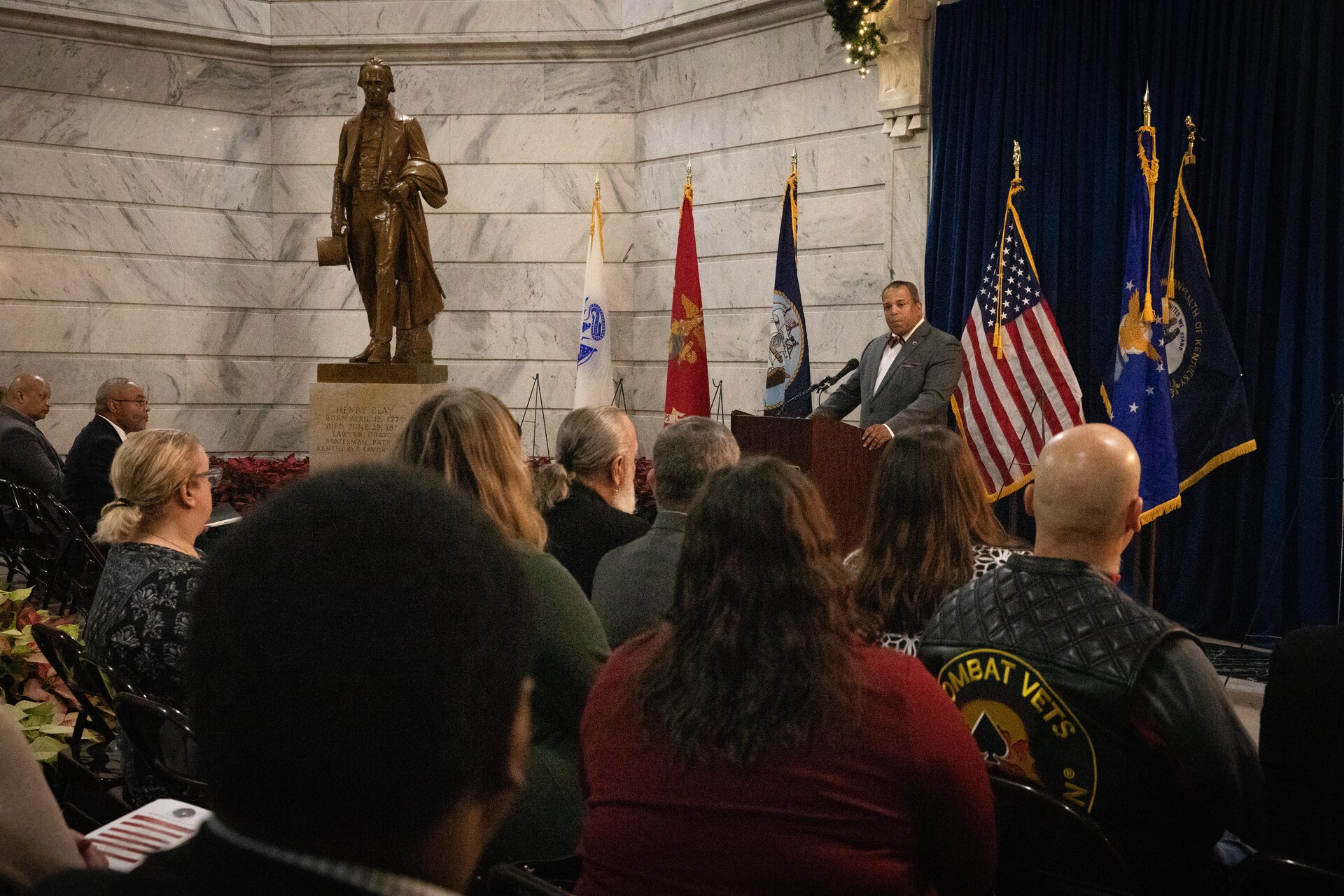 Mr. Juan Renaud speaks to the audience at the Kentucky Department of Veterans Affairs wreath laying ceremony at the Capitol Rotunda in Frankfort, Kentucky on Dec. 9, 2024. The Kentucky National Guard supported the ceremony by providing music from the 202nd Band and a color guard from the 63rd Theater Aviation Brigade. (U.S. Army National Guard photo by Andy Dickson)