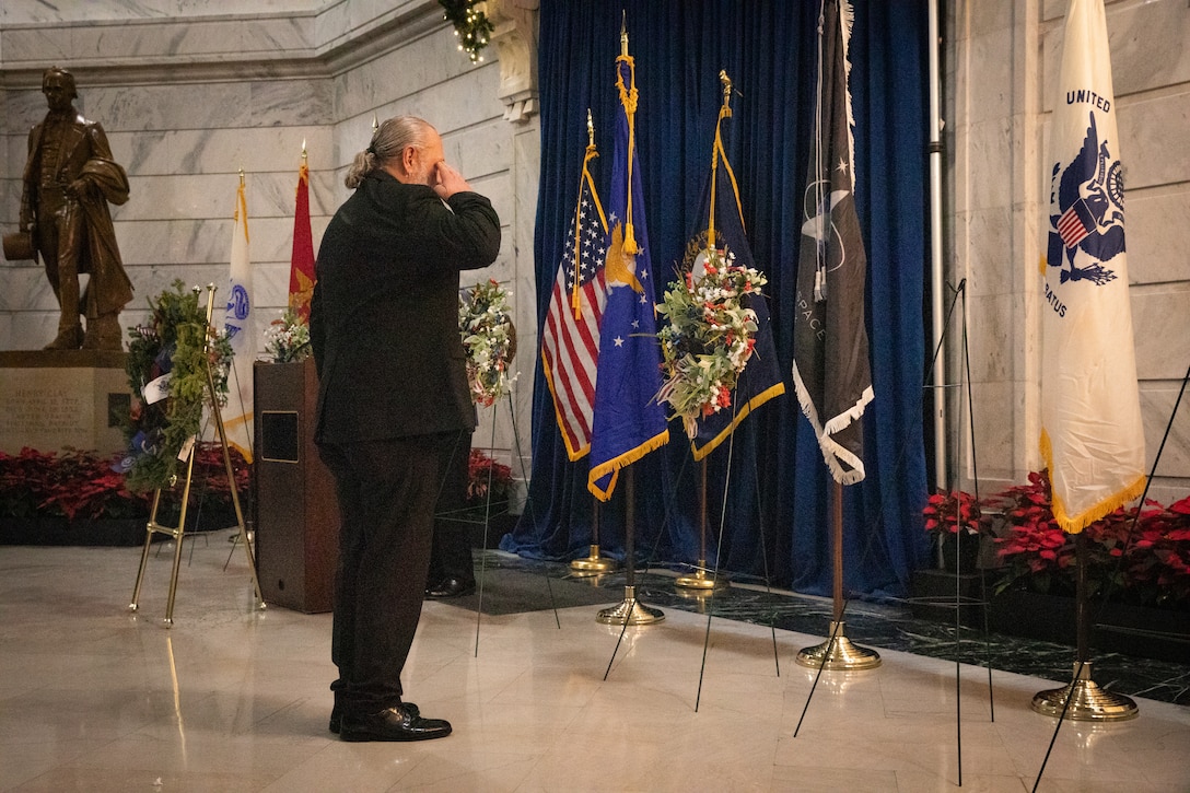 Mr. David Doss, an military veteran, salutes a wreath at the Kentucky Department of Veterans Affairs wreath laying ceremony at the Capitol Rotunda in Frankfort, Kentucky on Dec. 9, 2024. The Kentucky National Guard supported the ceremony by providing music from the 202nd Band and a color guard from the 63rd Theater Aviation Brigade. (U.S. Army National Guard photo by Andy Dickson)