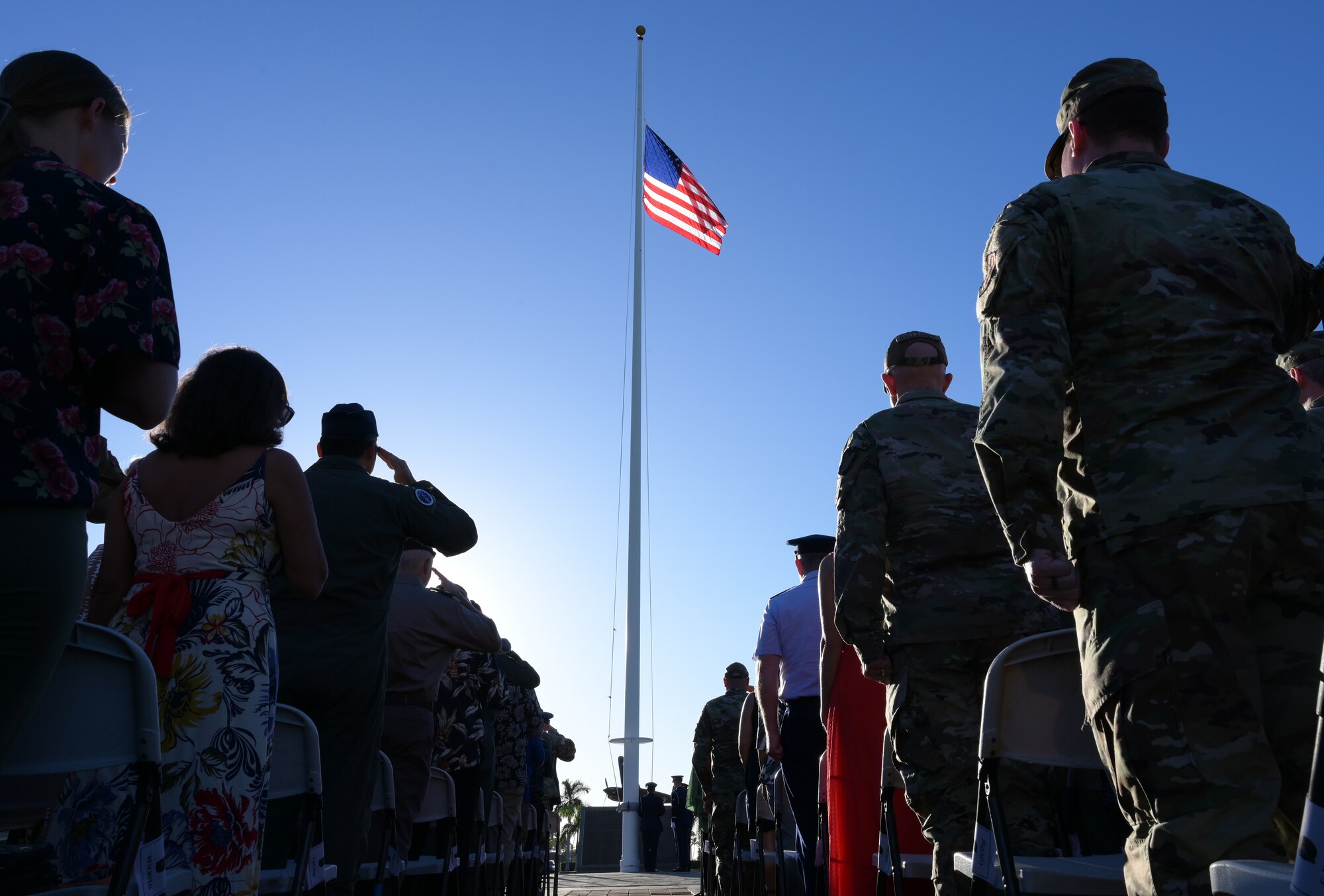 A U.S. flag is raised during a ceremony.