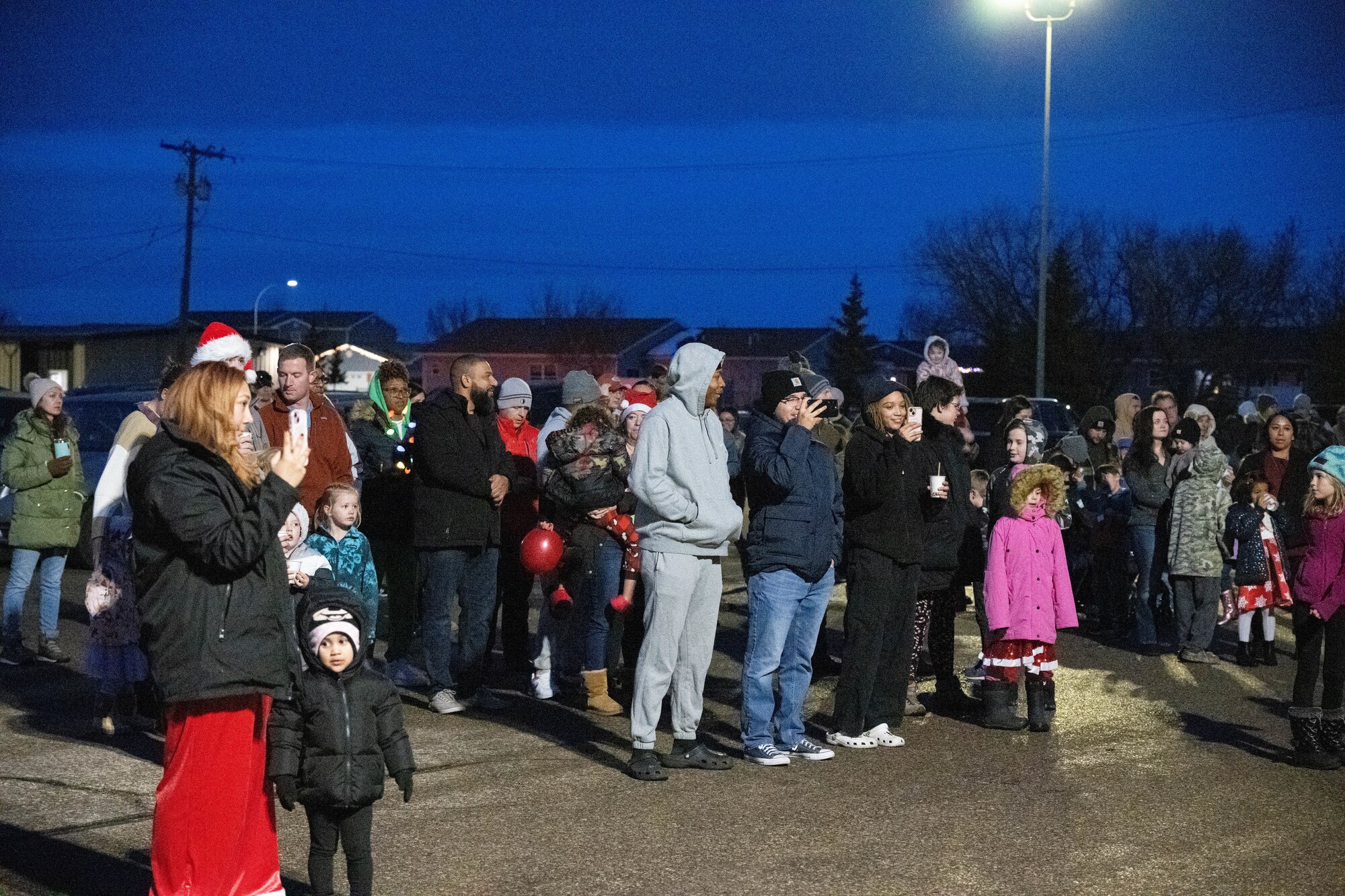 Team Minot gathers at the Northern Lights Chapel for a tree lighting ceremony at Minot Air Force Base, North Dakota, Dec. 7, 2024. The tree lighting was a community event held at the Northern Lights Chapel and facilitated by the chaplain corps and Minot leadership. (U.S. Air Force photo by Airman 1st Class Wesley Davies)