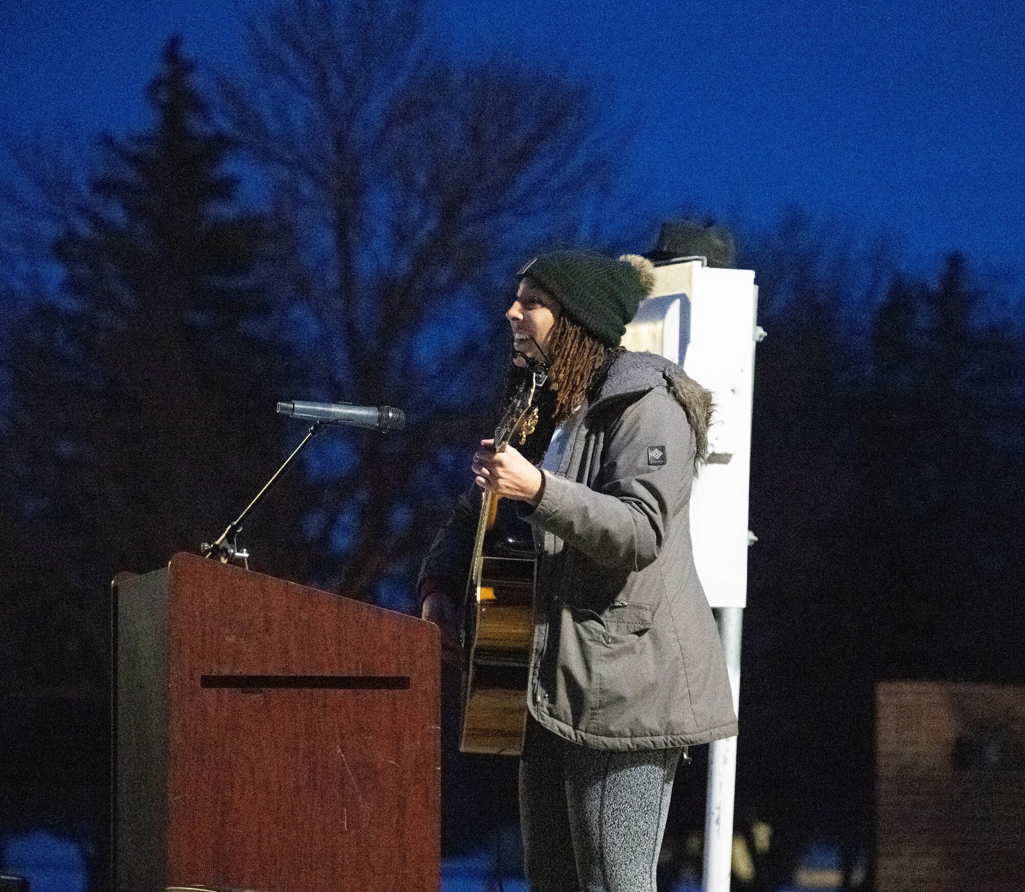 Senior Airman O’leesa James, Chaplain Corps religious affairs specialist, sings “Silent Night” for attendees of the tree lighting ceremony at the Northern Lights Chapel at Minot Air Force Base, North Dakota, Dec. 7, 2024. The earliest examples of tree lightings go back to the 1500s with candles and glass ornaments. (U.S. Air Force photo by Airman 1st Class Wesley Davies)