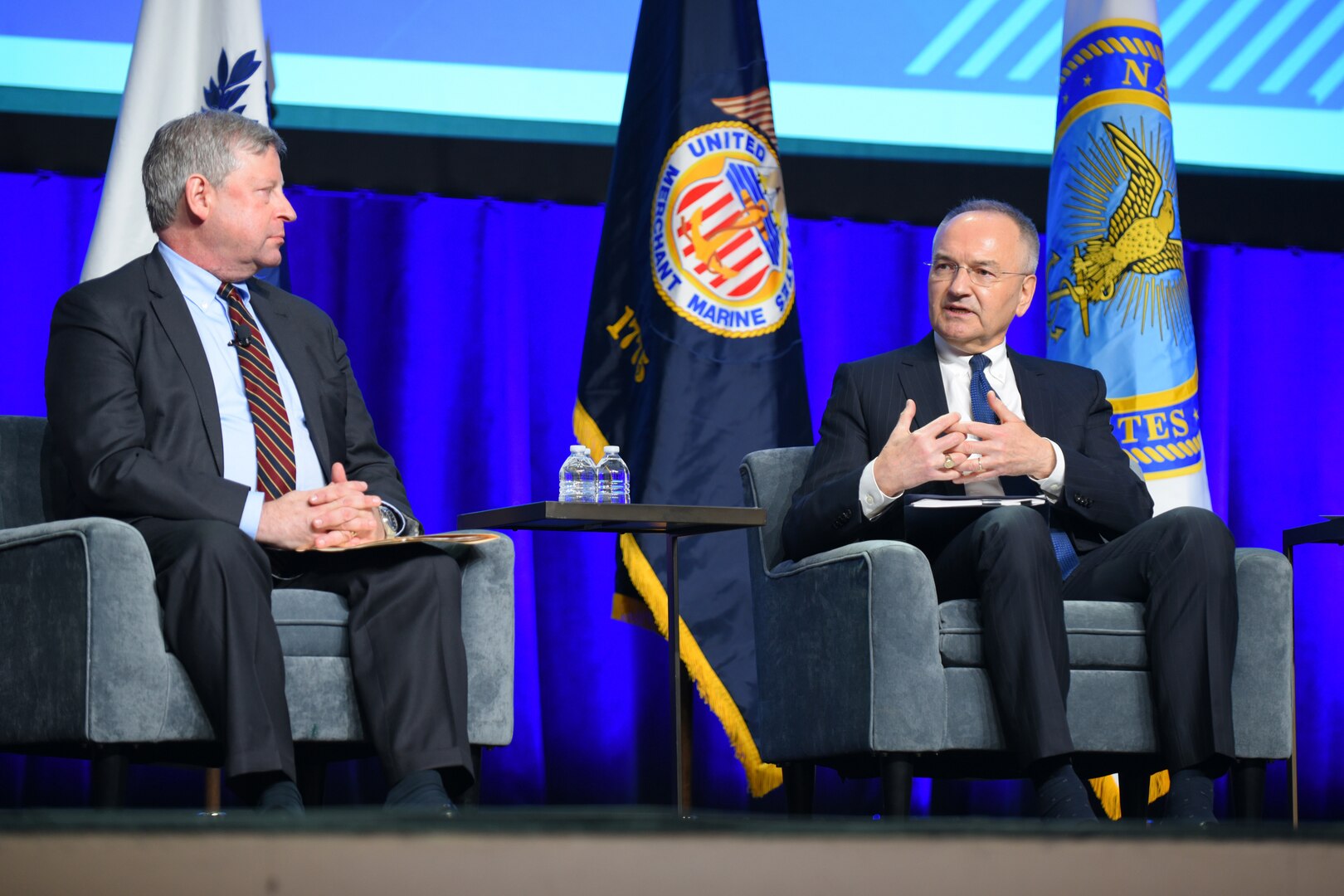 ames Hursch, left, director of the Defense Security Cooperation Agency and Andrew Michta, dean of the College of International and Security Studies at the George C. Marshall European Center for Security Studies, speak at the Navy League's 2023 Sea Air Space Conference and Exposition in Washington