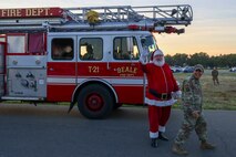 Santa Claus and U.S. Air Force Capt. Peter Vo, 9th Reconnaissance Wing chaplain, attend the annual Christmas Tree lighting at Beale Air Force Base, California, Dec. 6, 2024.