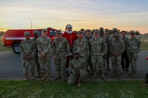 Santa Claus poses for a photo with members of the Beale Spiritual Intelligence Surveillance and Reconnaissance (ISR) team during the annual Christmas Tree lighting at Beale Air Force Base, California, Dec. 6, 2024.